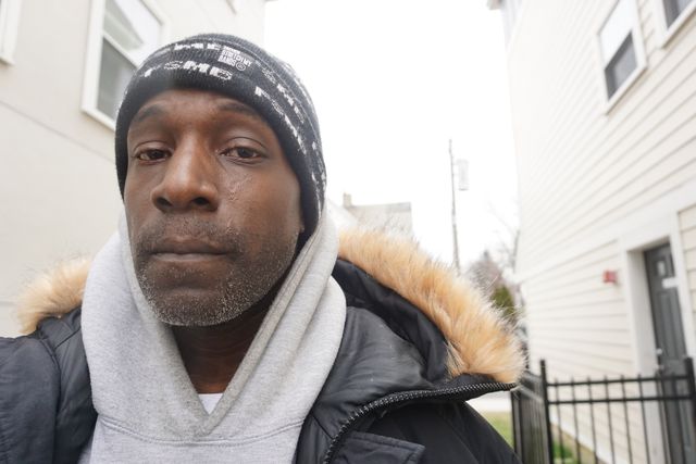 Henderson Clarke, accused of a drug sale in Mount Vernon, stands outside his mother’s apartment.